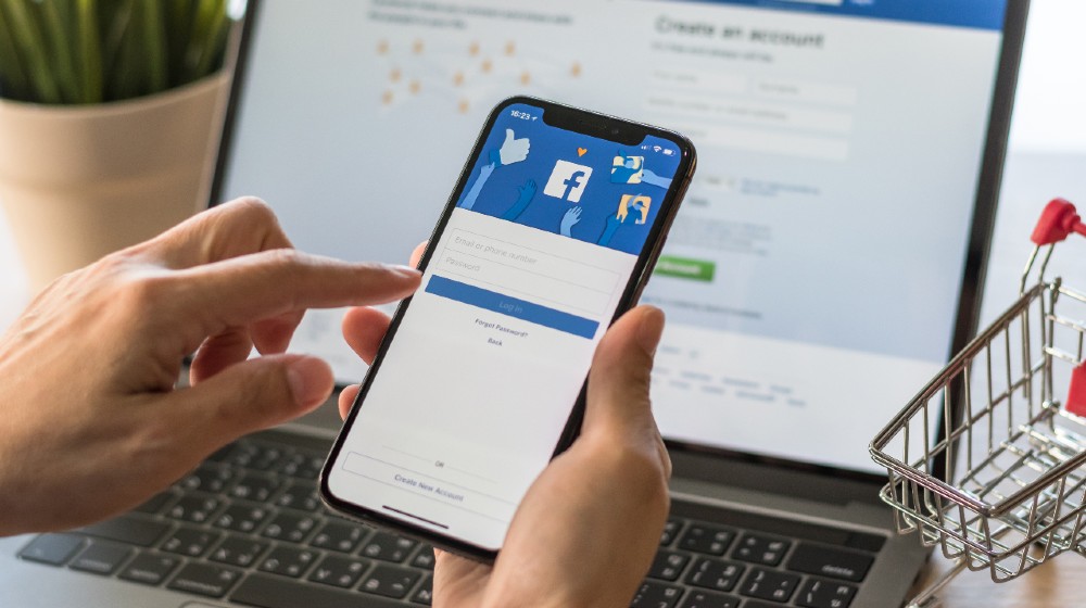 Facebook social media app logo on log-in sign-up registration page on mobile app screen on iPhone-facebook tightens political ad rules-ss-featured