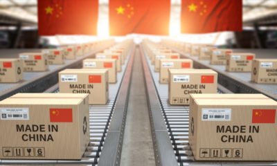 Made in China. Cardboard boxes with text made in China and chinese flag on the roller conveyor-China's 3rd Quarter GDP-ss-featured