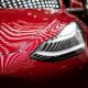 close-up photography of red car-Tesla Posts Profitable 3rd Quarter-us-featured
