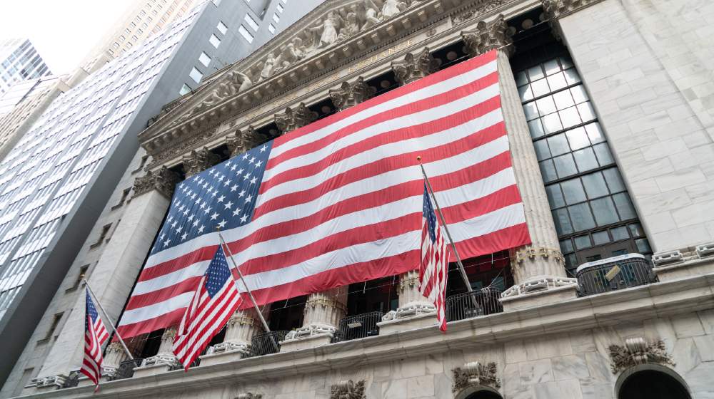 Upward View Of The NYSE With American Flag Draped Over Front Of Building In The Financial District Of Lower Manhattan-Stock Market Doesnt Care-ss-featured