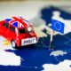 Red vintage car with Union Jack flag and brexit or bye words over an UE map and flag-Brexit Deal-ss-featured