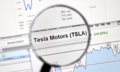 Tesla Motors stock market ticker with charts under magnifying glass-Tesla Enters S&P 500-ss-featured
