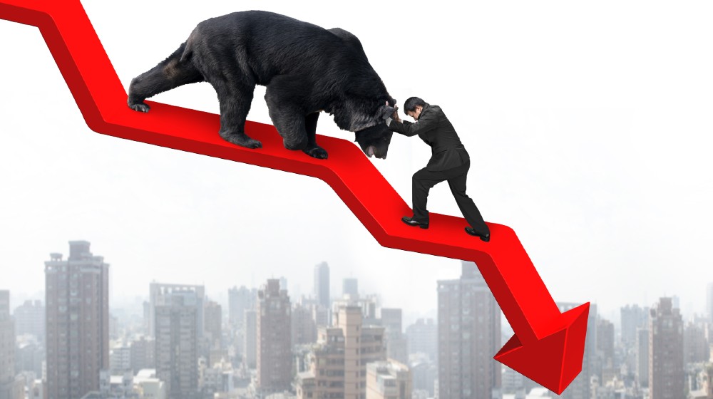 Businessman against black bear on red arrow downward trend line with sky cityscape-Stocks Will Fall-ss-featured