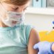 Little girl in face mask in doctor's office is vaccinated-COVID-19 Vaccines on Children-ss-featured | COVID-19 Vaccines on Children