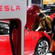 Visitors view a car from US electric car maker Tesla at Haikou New Energy Vehicle Exhibition in Haikou, south China's Hainan province, on Jan 10, 2019. [Photo/Xinhua]