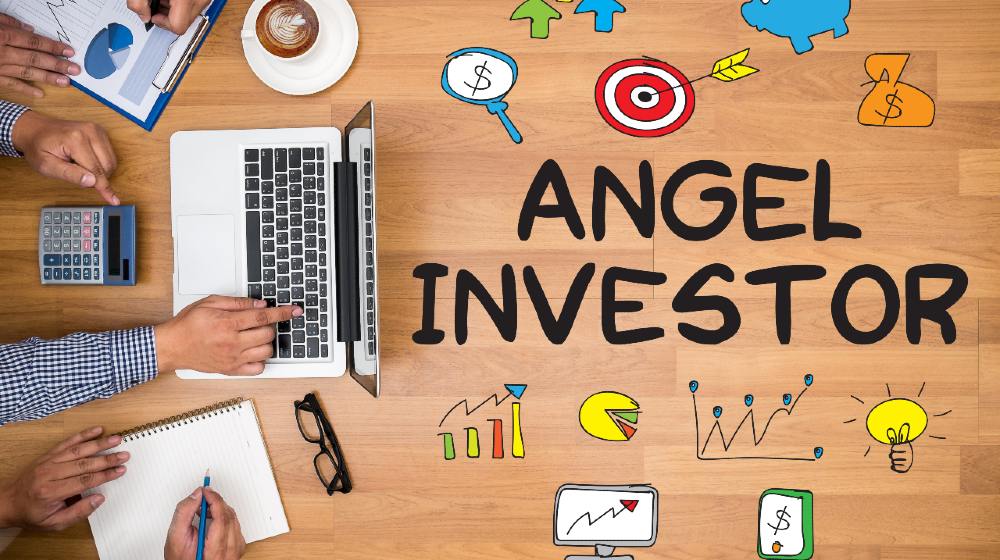 ANGEL INVESTOR Business team hands at work with financial reports and a laptop-angel investing-ss-featured