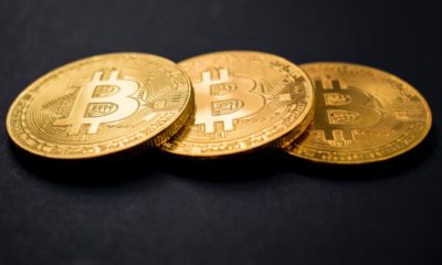 three gold-colored bitcoins | Bitcoin Prices Fall Below $50,000 As Tax Fears Surface | Featured