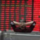 An investor watchs electric board in a stock market in Huaibei | What Is a "Blood in the Streets" Moment? | Featured