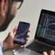 Business man trader investor analyst using mobile phone app analytics for cryptocurrency financial market analysis | Detailed Insight of Online Trading | Featured