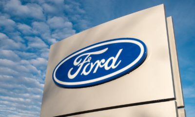 Ford dealership sign against a blue sky | Biden Seeks To Spend Hundreds of Billions in Taxpayer Money | Featured