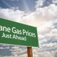Insane Gas Prices Green Road Sign with Dramatic Clouds, Sun Rays and Sky | Gas Prices Are Now Highest Since 2014 | Featured