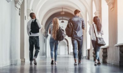 Multiracial students are walking in university hall during break and communicating | students have decided to pursue a tech career since the pandemic | featured