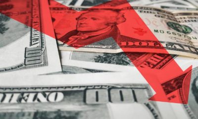 The bright red arrow icon on a background of money. The concept of changing course of US dollar on the market | The US Dollar Is Falling, And It Won’t Stop Falling Soon | Featured