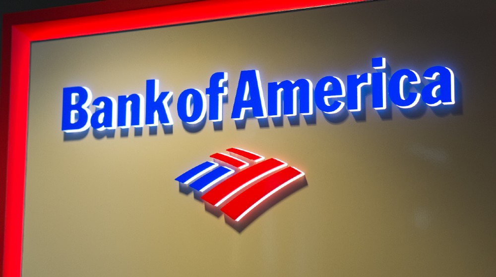 The logo of Bank of America in LAX airport. Bank of America is a banking and financial services corporation | Bank Of America To Raise Worker Pay to $25/hr By 2025 | Featured