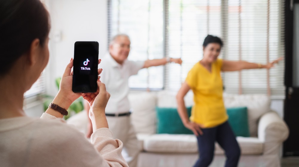 Asian woman using mobile phone take video clip of senior people dancing to share on tiktok application | Why And How To Leverage TikTok For Influencer Marketing | Featured