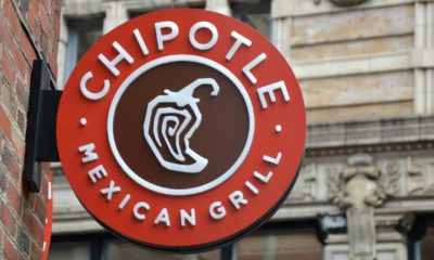 Chipotle Mexican Grill signboard on the wall in Boston. Chipotle is a chain of American restaurants | Chipotle To Raise Prices As Worker Pay Increases | featured
