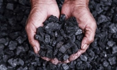 Coal mining coal miner in the man hands of coal background. Picture idea about coal mining or energy source | G7 Governments To End Support For Coal Power By 2021 | featured