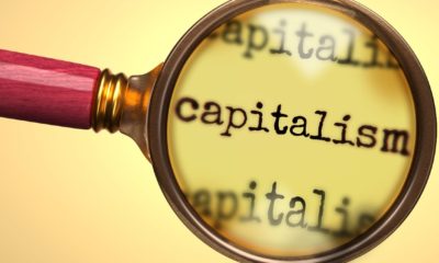 Examine and study capitalism, showed as a magnify glass and word capitalism | Are We (Finally) Ready For Compassionate Capitalism? | Featured