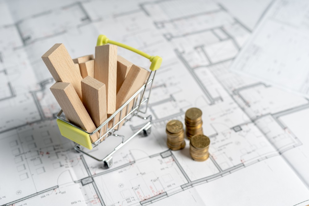 construction spending - High and low price concept. High angle above top view small miniature object of shopping cart full of sawmill construction materials | Timber! Lumber Prices Finally Going Down | featured