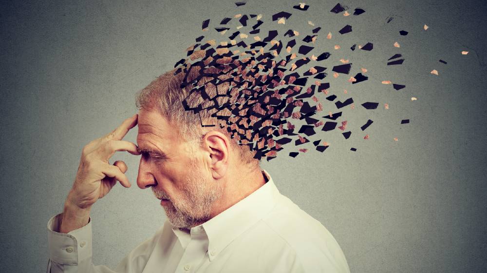 Memory loss due to dementia. Senior man losing parts of head as symbol of decreased mind function | FDA Approves New Alzheimer’s Drug From Biogen | featured