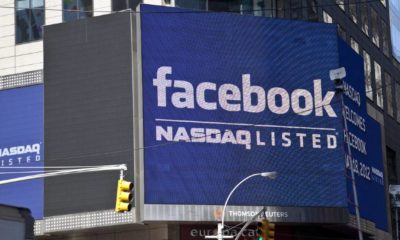 Sign announcing Facebook IPO is flashed on a screen outside the Thomson Reuters building | Facebook Hits $1 Trillion Cap As Antitrust Suits Dismissed | featured