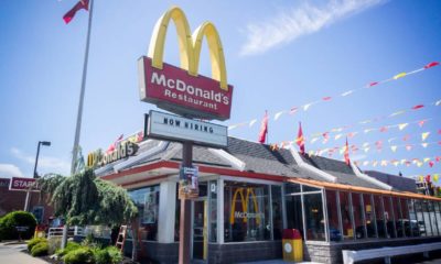 A McDonald's restaurant with a hiring sign in Queens in New York | McDonald’s Offering Tuition and Childcare to Attract Workers | featured