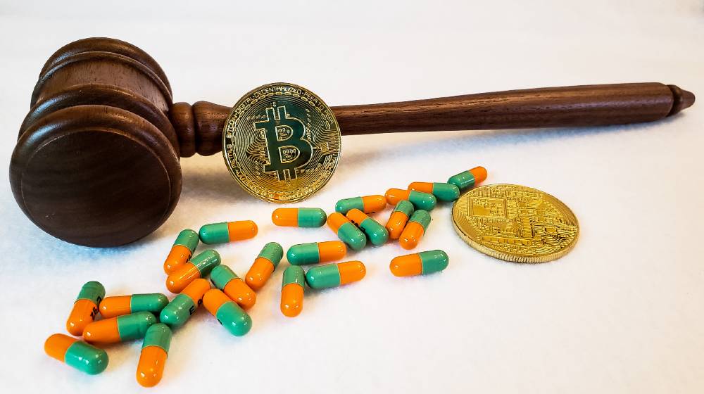A gavel with medication and bitcoins on a white background. Medical malpractice and legal virtual currency | Get to Know About the Bitcoin Malpractices That Exist | featured