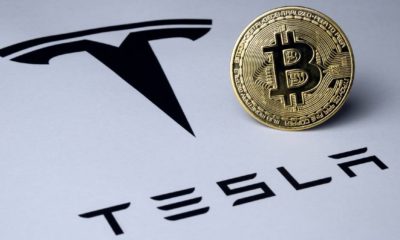 Bitcoin and Tesla logo seen on paper document | Elon Musk Says Tesla Will Accept Bitcoin Again Soon | featured
