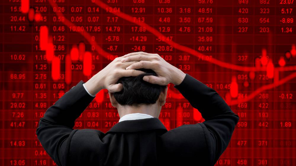 Businessman put his hands on his head feeling nervous and anxious about bad business | Bear Says Now Is Not A Good Time to Invest in Stocks | featured