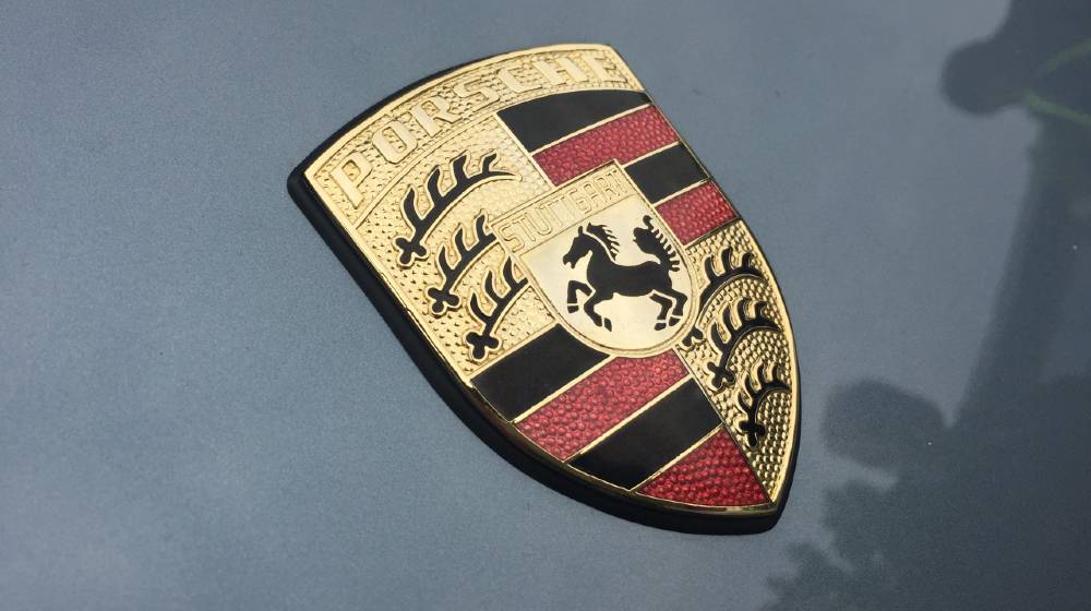 Porsche symbol on black car. Porsche AG is a German automobile manufacturer | Porsche SE Is Latest Company To Join The Space Race | featured