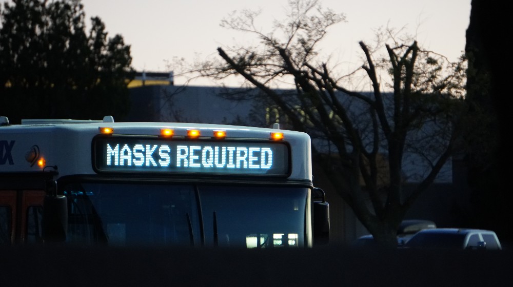 Bus Displays Sign That People Must Wear Their Masks | US to Extend Public Transport Mask Mandate Until January 18 | featured