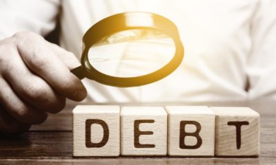 Businessman explores debt. Study of the structure of debt | All About Cleaning Up Your Credit & Choosing the Right Service | featured