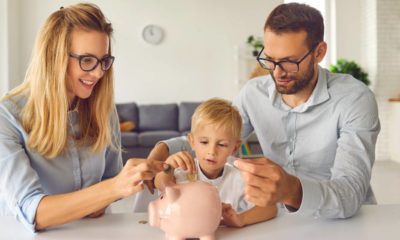 Little child puts money inside piggy bank, learns to effectively manage budget and spend wisely | Fun Ways to Teach Kids About Money | featured