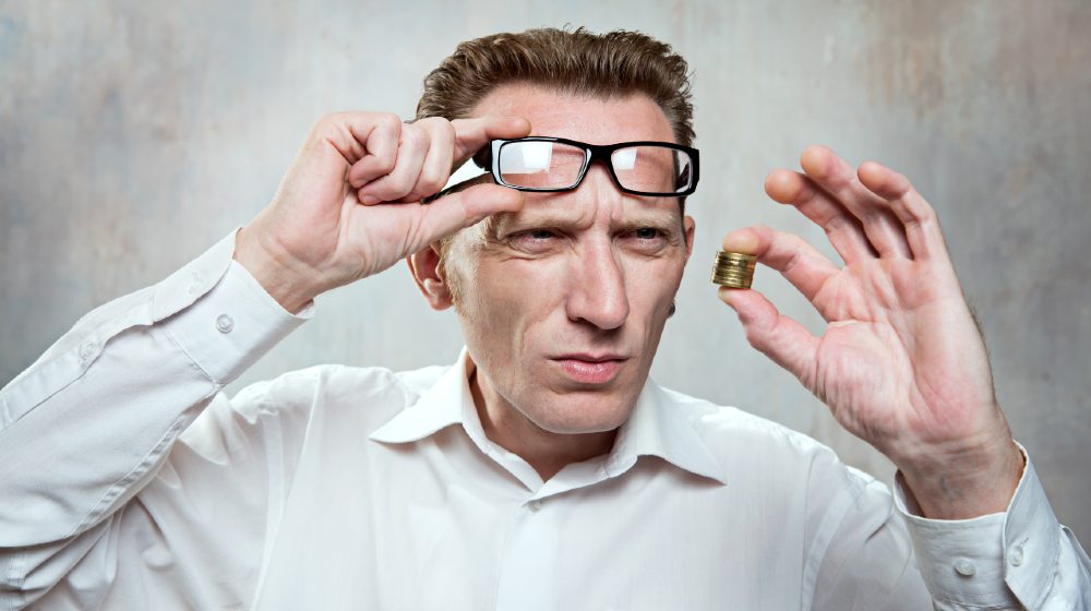 Office worker up his eyeglasses and look for a coins extremely surprise. Small salary concept | Runaway Inflation Is Wiping Out Gains From Higher Wages | featured