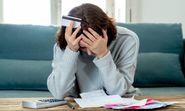 Young attractive woman looking stressed and worried with card payments and home finances | Major Causes of Financial Problems | featured