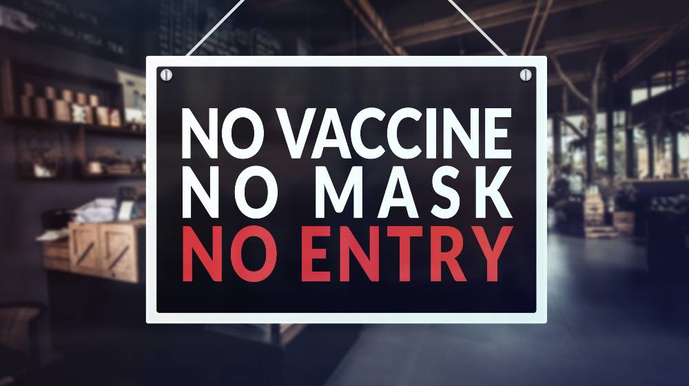 A no vaccine, no mask, no entry sign at a restaurant, cafe or other establishment | Biden Slams Unvaccinated Americans, Orders Vaccine Mandates | featured