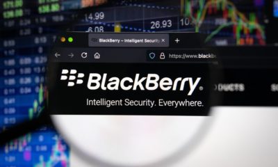 BlackBerry company logo on a website with blurry stock market developments in the background | TD Securities Raises BlackBerry Price Target to $9.00 | Featured