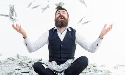 Businessman is happy with his money. Banknotes, cash dollars fly in air | Wealthiest 1% Americans Owe $163 Billion Yearly In Taxes | featured
