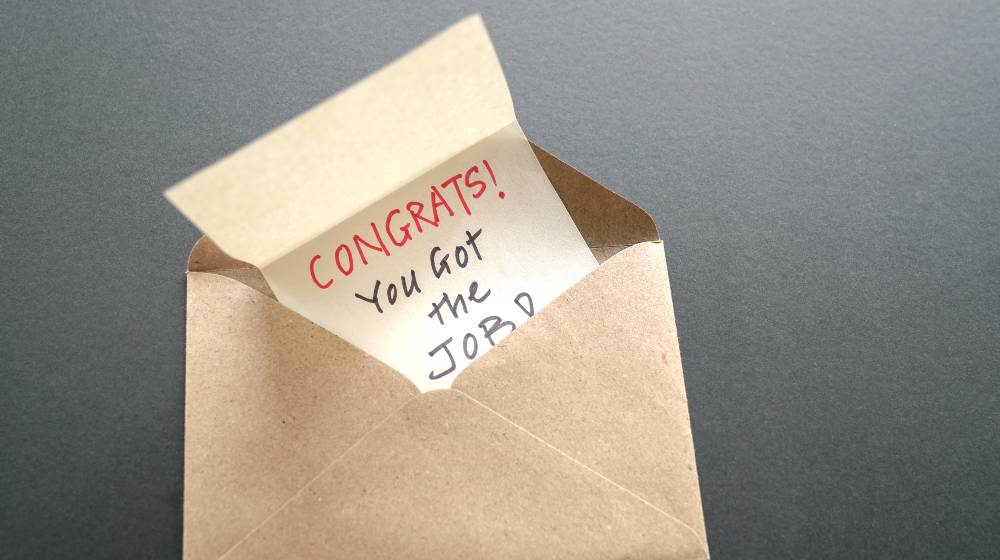Congrats you got the job, a message inside a brown envelope | Weekly Jobless Claims Fall As Layoffs Post 24-Year Low | featured