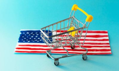 Mini supermarket shopping cart and abstract hand drawn American flag | US Retail Sales Increase Even As Delta Runs Wild | featured