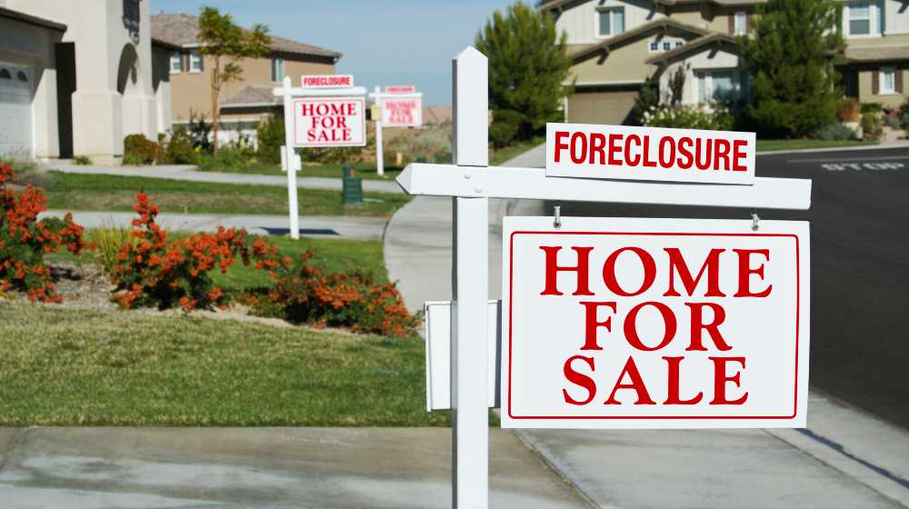 Row of Foreclosure Home For Sale Real Estate Signs in Front of Houses | US Housing Crisis Worsens, Market Short by 5 Million Homes | featured