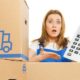 Woman with moving boxes with big calculator | Prepare For Higher Prices of Goods As Freight Costs Rise | featured