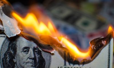 A hundred dollar bill in American US currency is on fire | Biden's inflation hits Thanksgiving dinner | featured