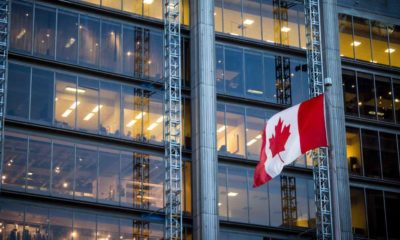 Canadian flag in front of a business building in Toronto, Ontario, Canada | Doing Business In Canada: What You Should Know | featured
