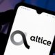 In this photo illustration the Altice USA logo | Altice USA, Inc. (NYSE:ATUS) Holdings Raised by Bleichroeder LP | featured