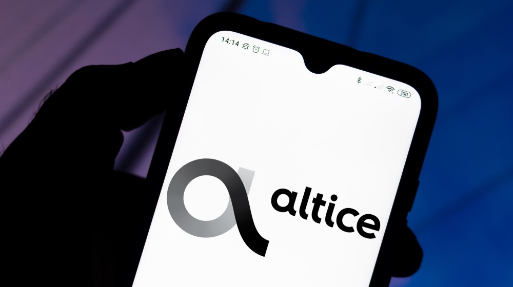 In this photo illustration the Altice USA logo | Altice USA, Inc. (NYSE:ATUS) Holdings Raised by Bleichroeder LP | featured