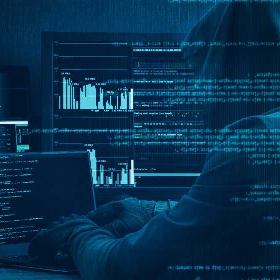 Internet crime concept. Hacker working on a code on dark digital background with digital interface around | Cyber criminals never sleep | featured