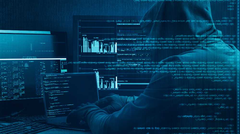 Internet crime concept. Hacker working on a code on dark digital background with digital interface around | Cyber criminals never sleep | featured