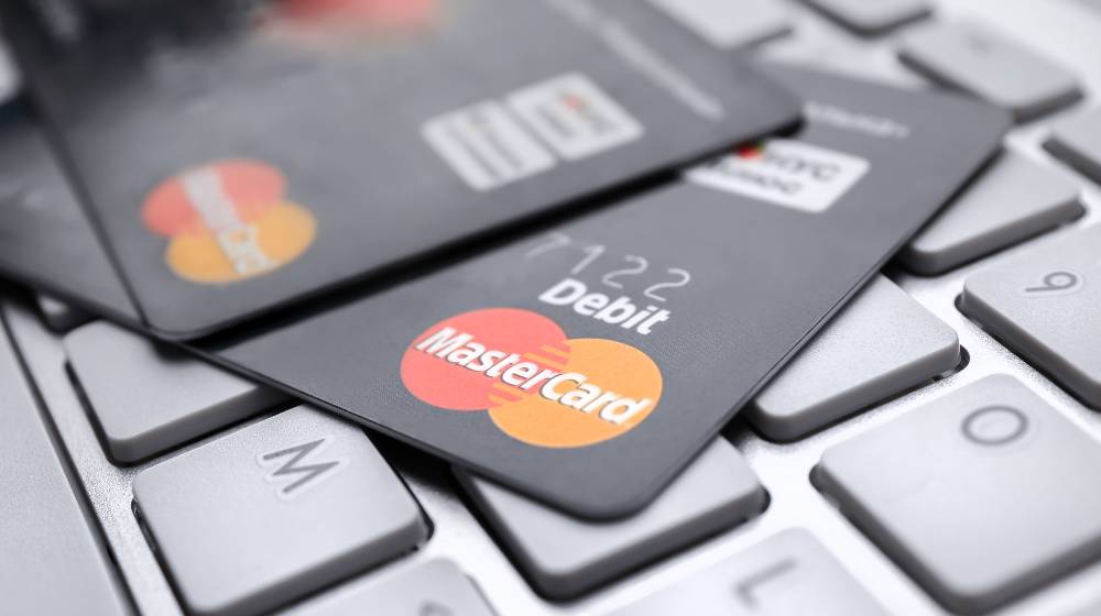 MasterCard credit cards on keyboard | Mastercard Will Offer Crypto Services In Its Merchant Banks | featured