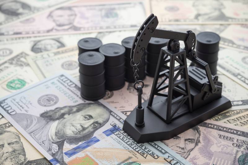 Oil pump jack and barrels on US dollar banknotes-Demand for Oil